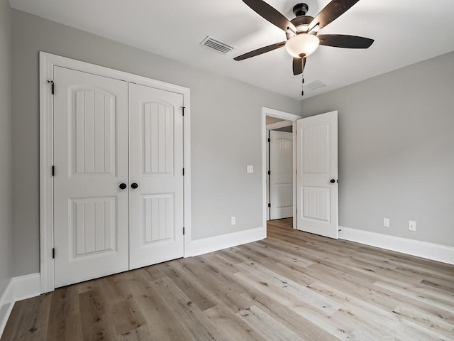 unfurnished bedroom featuring ceiling fan, light hardwood / wood-style floors, and a closet