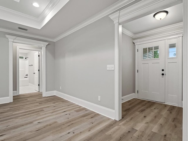 foyer entrance featuring light hardwood / wood-style flooring and ornamental molding