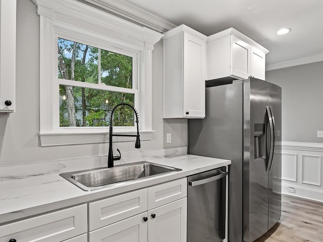 kitchen featuring sink, white cabinets, and appliances with stainless steel finishes