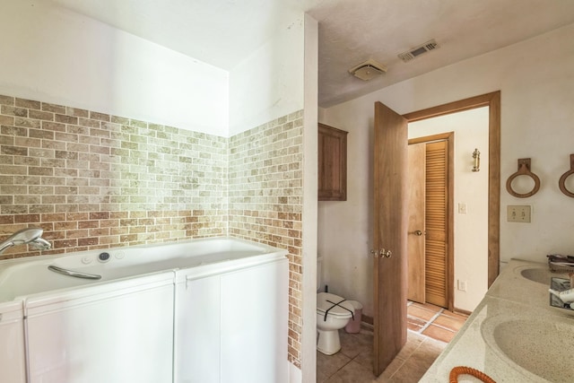 washroom with light tile patterned flooring and sink