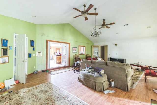 living room with ceiling fan, light wood-type flooring, and lofted ceiling