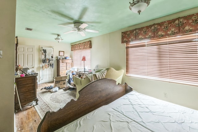 bedroom with light hardwood / wood-style floors and ceiling fan