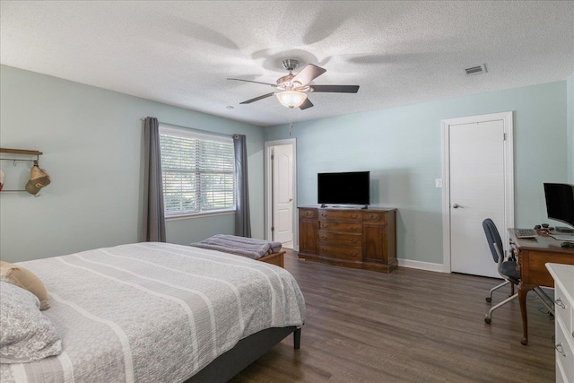 6447 Joe Cotton Trl, Tallahassee, FL 32309 - bedroom with dark wood-type flooring, a desk, a textured ceiling, a ceiling fan, and baseboards