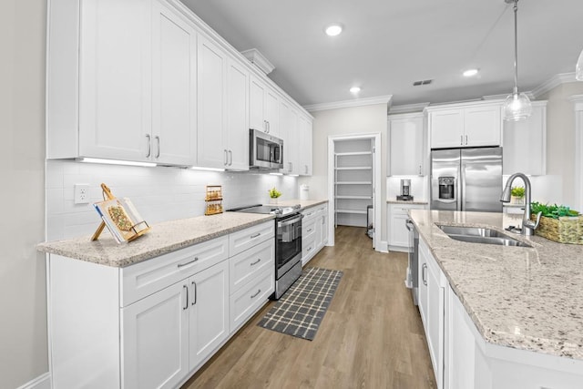 kitchen with white cabinetry and appliances with stainless steel finishes