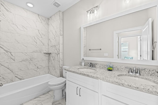 full bathroom with vanity, toilet, and tiled shower / bath