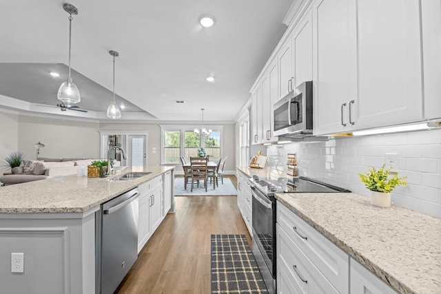 kitchen featuring sink, a center island with sink, white cabinets, and appliances with stainless steel finishes