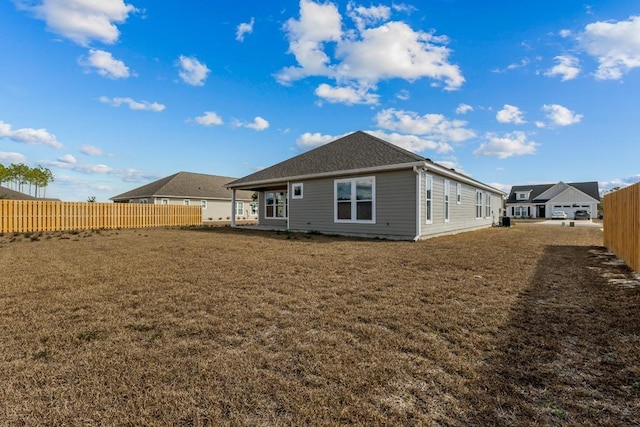 back of house featuring a yard