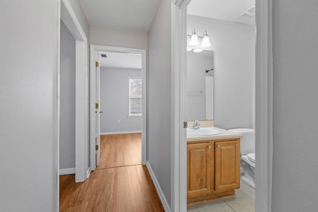 hall featuring sink and light hardwood / wood-style floors