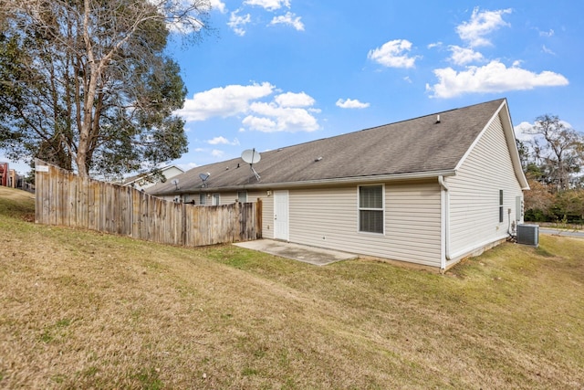 back of house featuring a yard, a patio, and central air condition unit