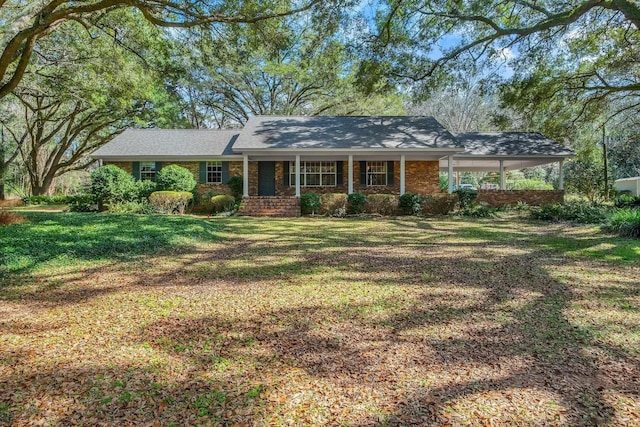 ranch-style home with covered porch and a front lawn