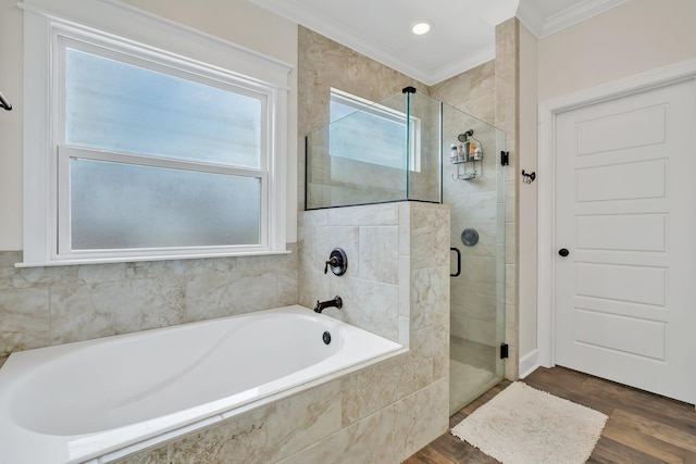 bathroom featuring crown molding, a shower stall, a garden tub, and a healthy amount of sunlight