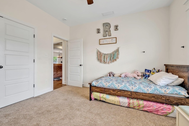 carpeted bedroom with a ceiling fan and baseboards
