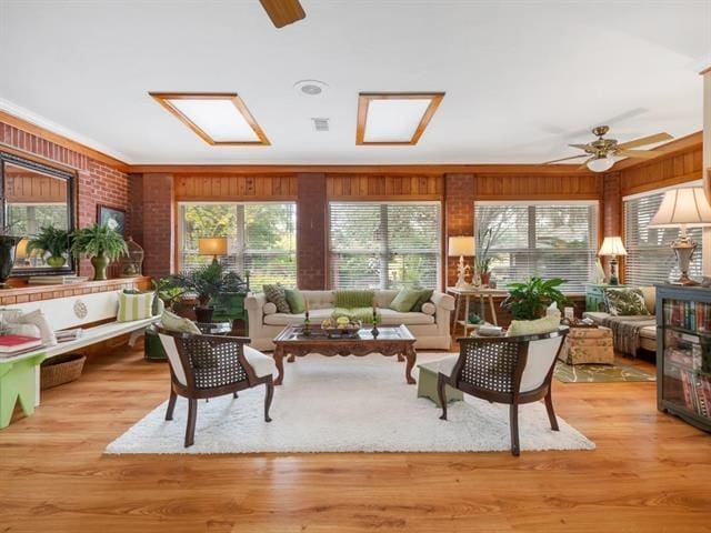 sunroom / solarium featuring a skylight and ceiling fan