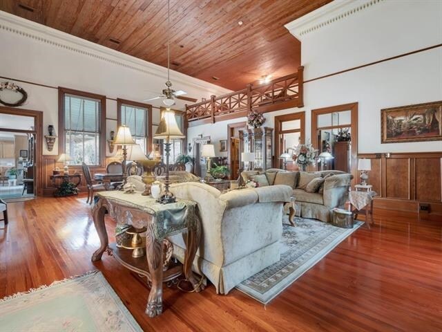 living room featuring hardwood / wood-style floors, ceiling fan, and wood ceiling