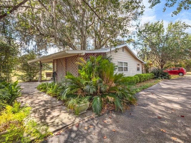 view of side of property featuring a carport