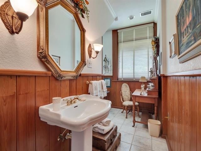 bathroom with wooden walls and tile patterned floors