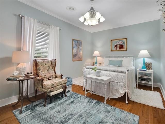 bedroom with dark hardwood / wood-style flooring, a notable chandelier, and ornamental molding