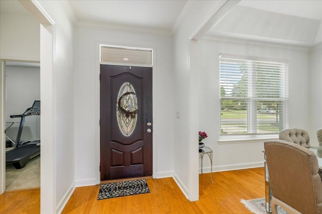 foyer with light hardwood / wood-style floors and crown molding