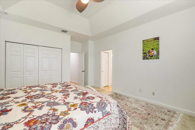 bedroom featuring ceiling fan, a closet, and lofted ceiling