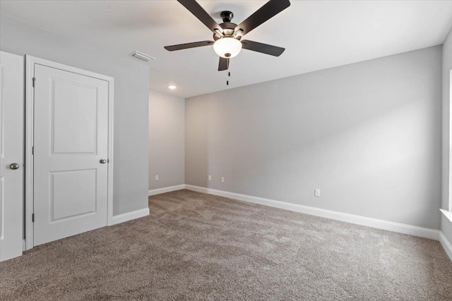 empty room featuring a ceiling fan, carpet flooring, baseboards, and visible vents