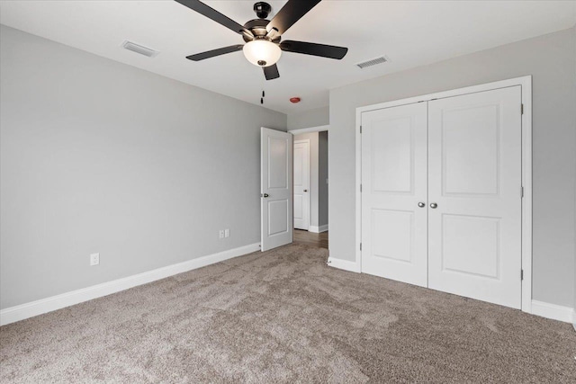 unfurnished bedroom featuring visible vents, baseboards, and carpet