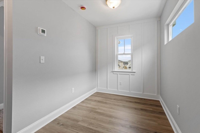 empty room with baseboards and light wood-style flooring