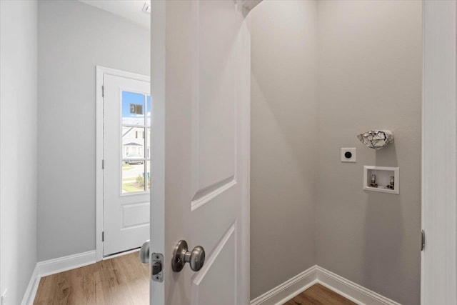 laundry room featuring wood finished floors, baseboards, hookup for an electric dryer, laundry area, and washer hookup