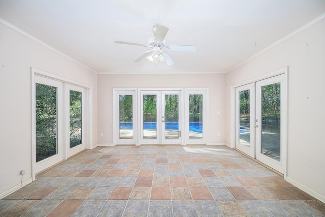 spare room with ornamental molding, stone finish flooring, french doors, and baseboards