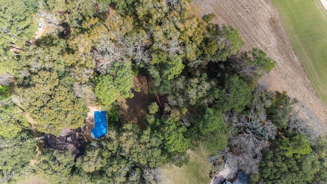 drone / aerial view featuring a wooded view