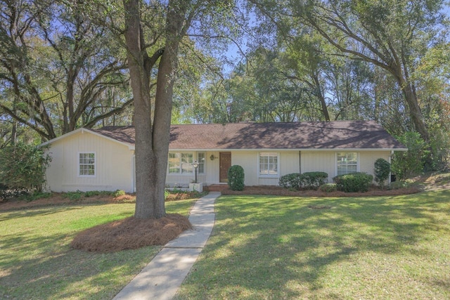 ranch-style home with a front lawn