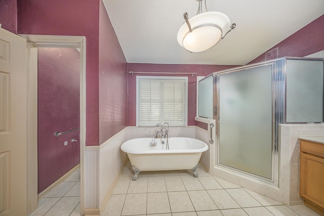 full bath with a wainscoted wall, a soaking tub, tile patterned flooring, vanity, and a shower stall