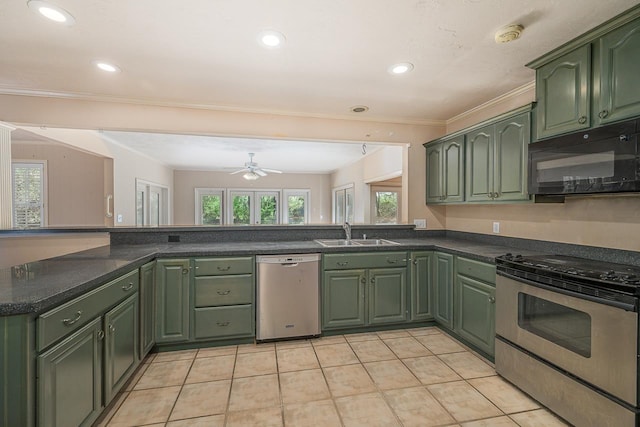 kitchen featuring light tile patterned floors, stainless steel appliances, green cabinets, ornamental molding, and a sink