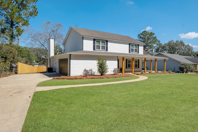 view of front facade with a chimney, covered porch, a front yard, fence, and driveway