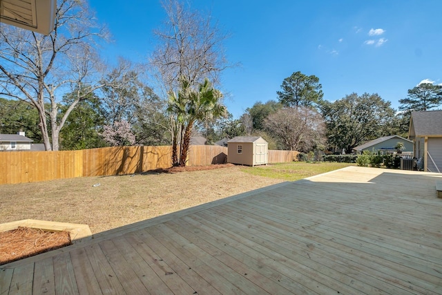 deck with a yard, a storage unit, an outdoor structure, and a fenced backyard