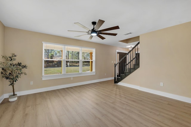 interior space with light wood finished floors, stairway, visible vents, and baseboards