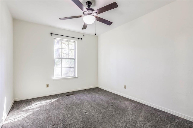 unfurnished room with carpet floors, visible vents, baseboards, and a ceiling fan