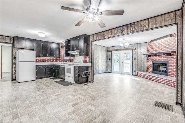 kitchen featuring white appliances, visible vents, open floor plan, light countertops, and open shelves