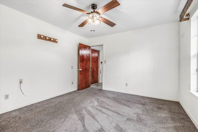 unfurnished room featuring ceiling fan, carpet, and baseboards