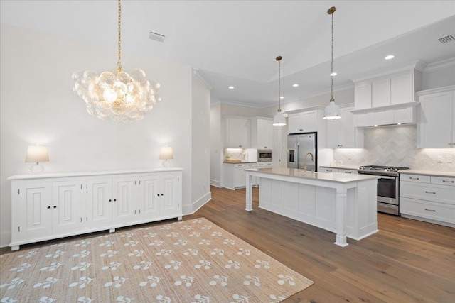 190 Camellia Oaks Ave Unit 96, Tallahassee, FL 32317 - kitchen featuring stainless steel appliances, ornamental molding, decorative backsplash, light countertops, and white cabinetry