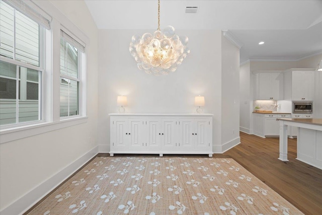 190 Camellia Oaks Ave Unit 96, Tallahassee, FL 32317 - unfurnished dining area featuring a chandelier, wood finished floors, and ornamental molding