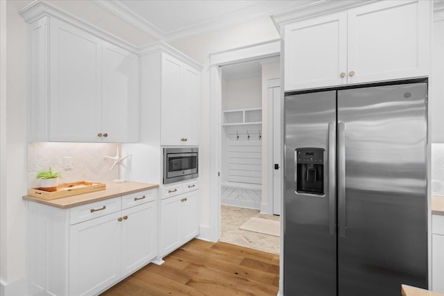 190 Camellia Oaks Ave Unit 96, Tallahassee, FL 32317 - kitchen with appliances with stainless steel finishes, ornamental molding, light wood-style floors, decorative backsplash, and white cabinets