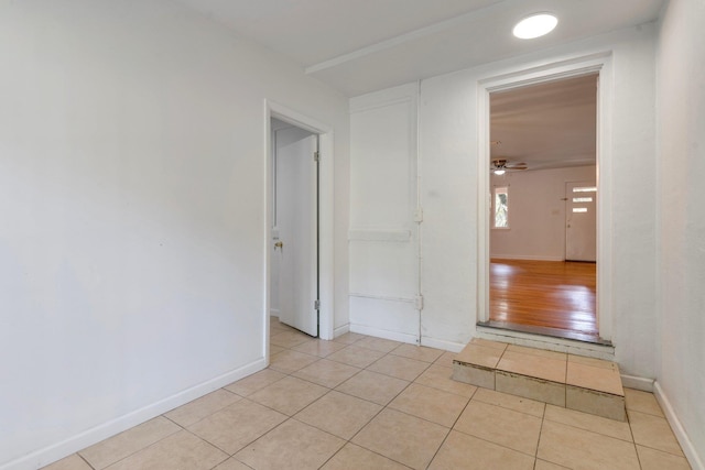 empty room featuring ceiling fan and light hardwood / wood-style flooring