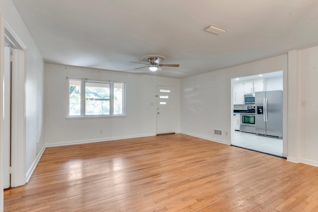 unfurnished living room featuring ceiling fan and light hardwood / wood-style flooring