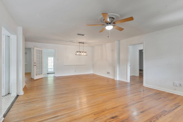 empty room with ceiling fan and light wood-type flooring