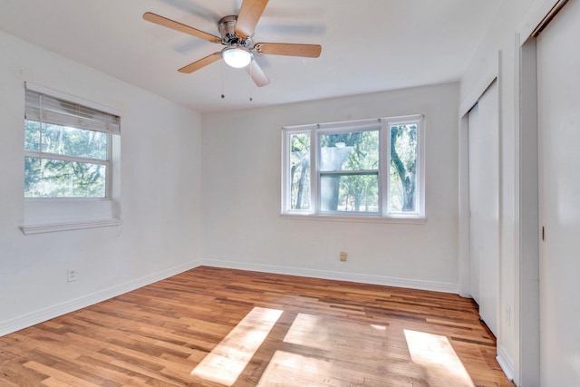 unfurnished bedroom with ceiling fan and light wood-type flooring