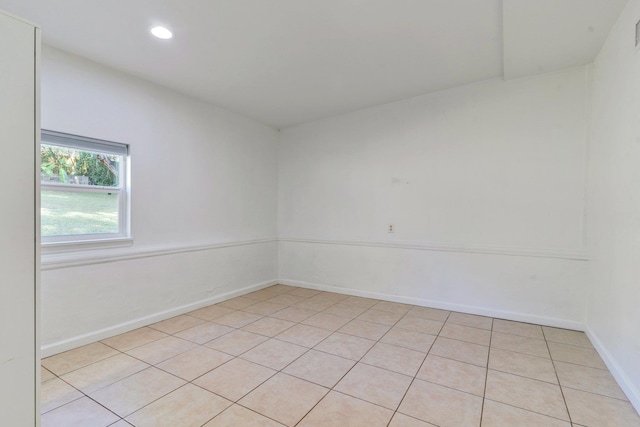 spare room featuring light tile patterned flooring