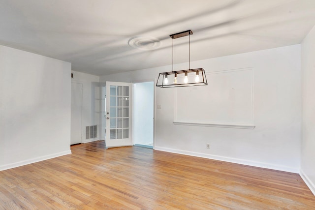 unfurnished dining area with french doors and light hardwood / wood-style flooring