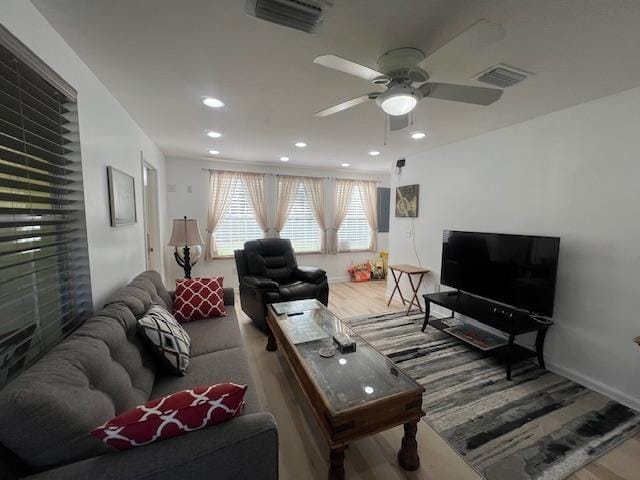 living room featuring hardwood / wood-style flooring and ceiling fan