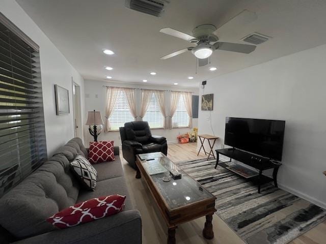 living room with hardwood / wood-style floors and ceiling fan