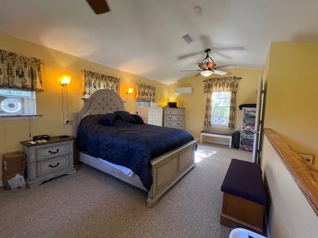 bedroom featuring a wall mounted AC, lofted ceiling, light carpet, and ceiling fan